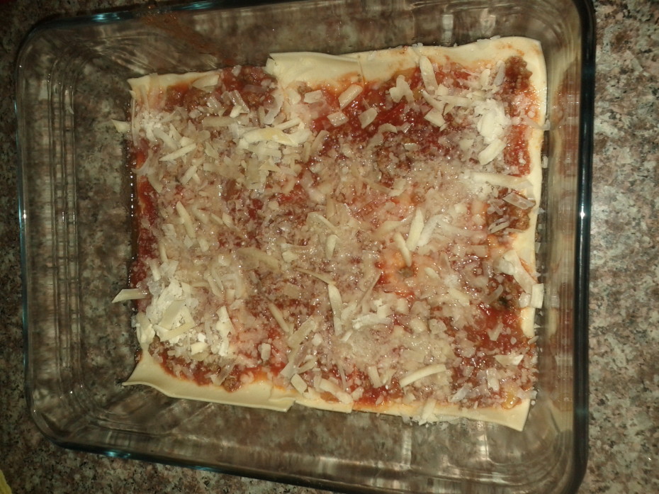 Layer 3, tomato sauce topped with Parmesan (Parmigiano) Cheese